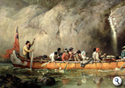 Voyageurs paddle by a waterfall in Ontario