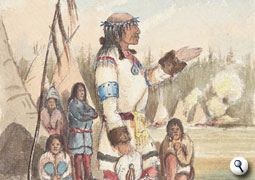 Native man addresses a group in a camp